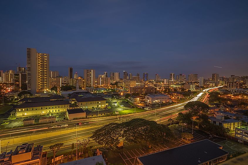 Night panorama of East Honolulu with steady heavy traffic on the H-1 Freeway