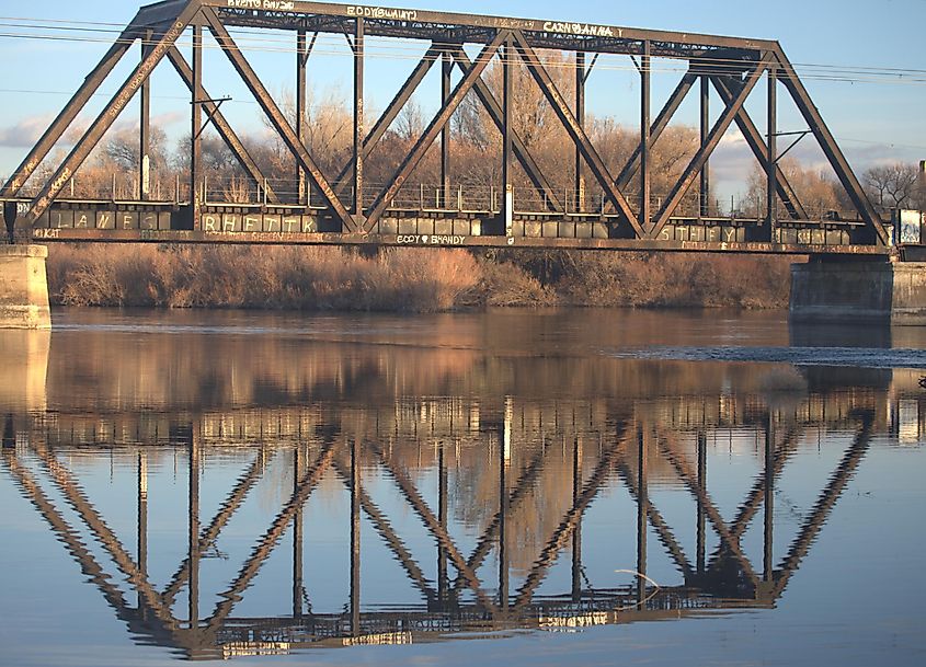 Reflection of an old train bridge over the Snake River in Blackfoot, Idaho.