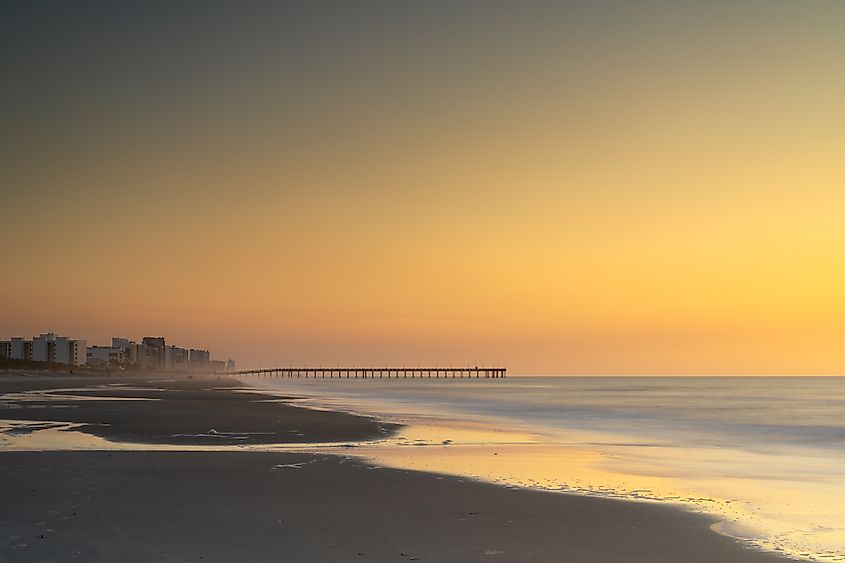 A landscape view of Springmaid Beach and pier at the south end of Myrtle Beach's Grand Strand at sunrise