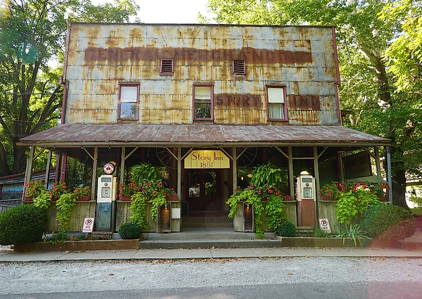 Story Inn in Story, Indiana, a historic wood-frame building with a covered porch, rustic signage, and surrounded by trees in a quiet rural setting