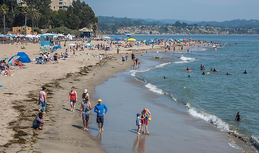 People, including families and friends, enjoy a sunny summer day along the Pacific Coast at the beach in Capitola, in Santa Cruz County.
