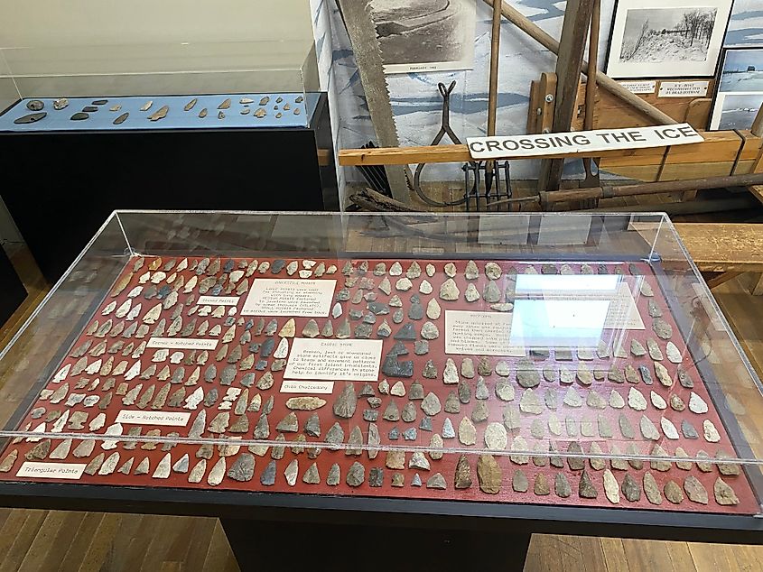 A glass case filled with stone arrowheads.