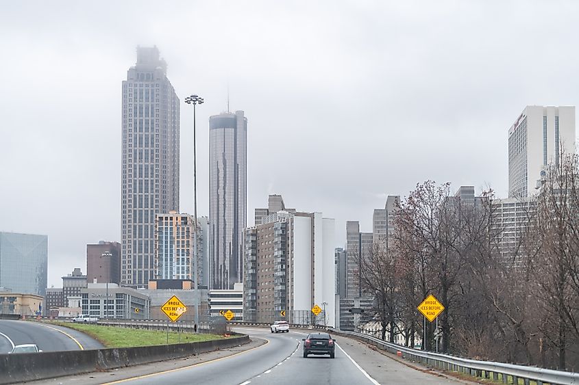 Atlanta, Georgia: Highway interstate 85 road street in Atlanta in capital Georgia city with view of cityscape skyline on cloudy rainy day weather