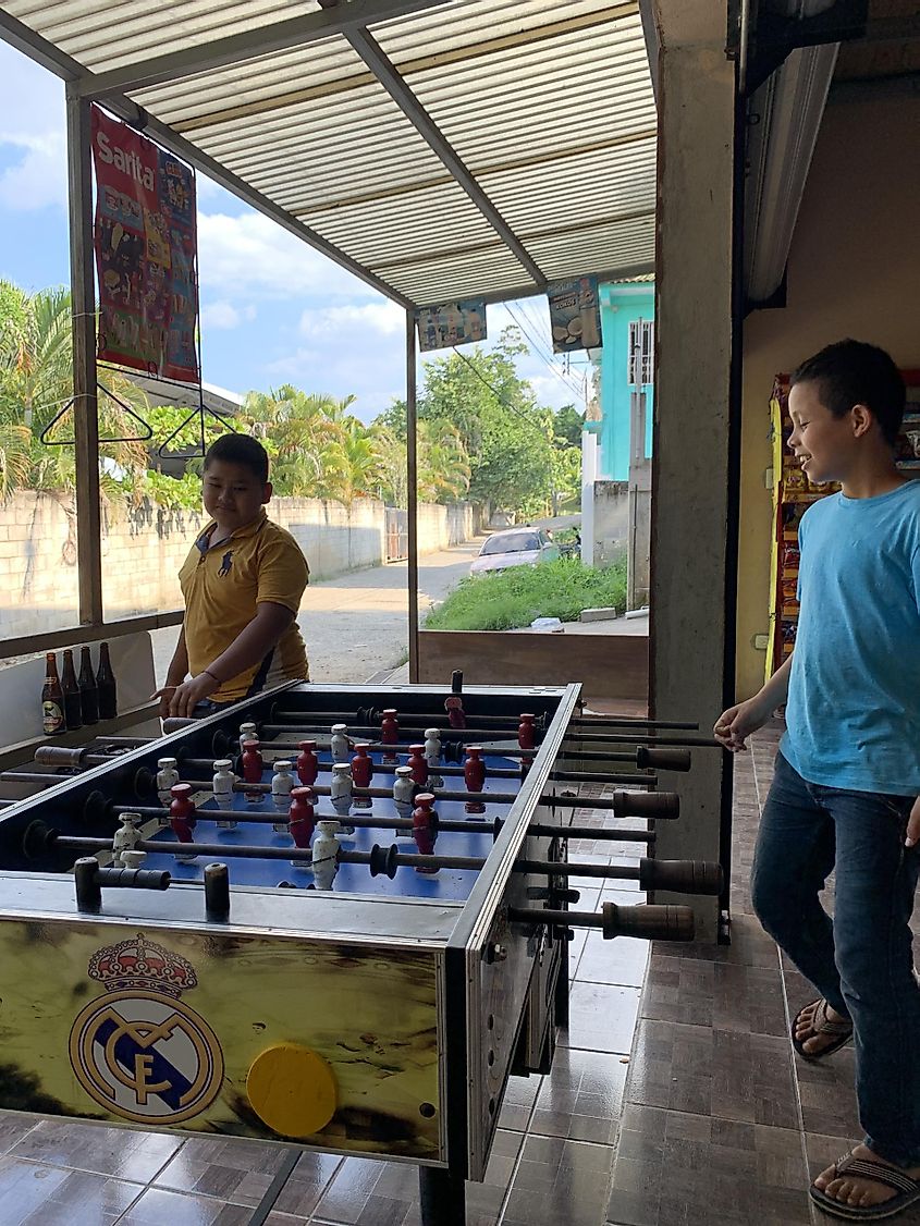 Two young boys playing foosbol at the local store