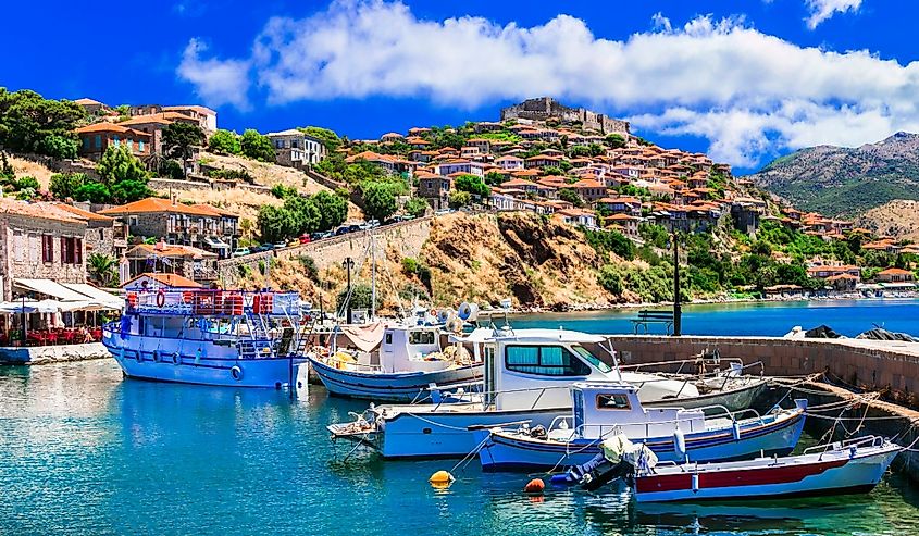 Best of Greece - scenic Lesvos island. Molyvos (Mythimna) town. view of marine with traditional boats and castle