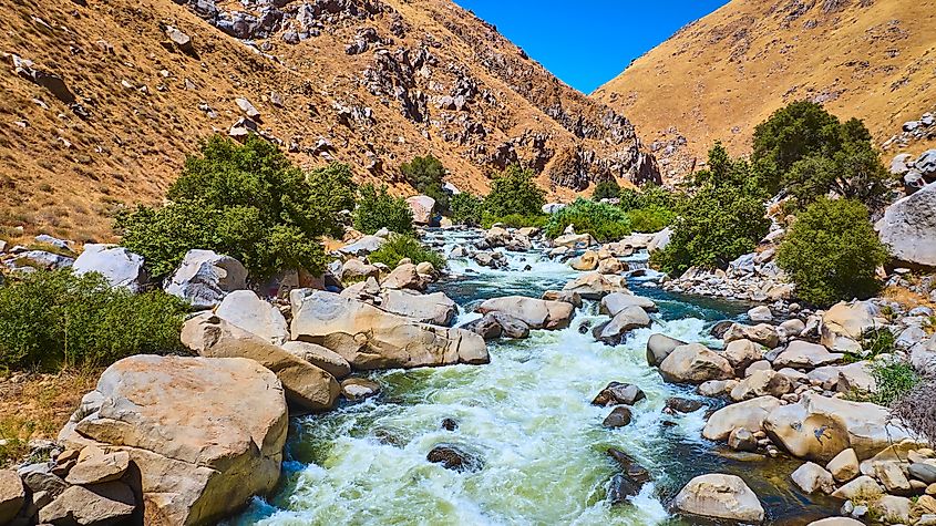 Kern River cascades and boulders in a sunlit California canyon in Sequoia National Park.