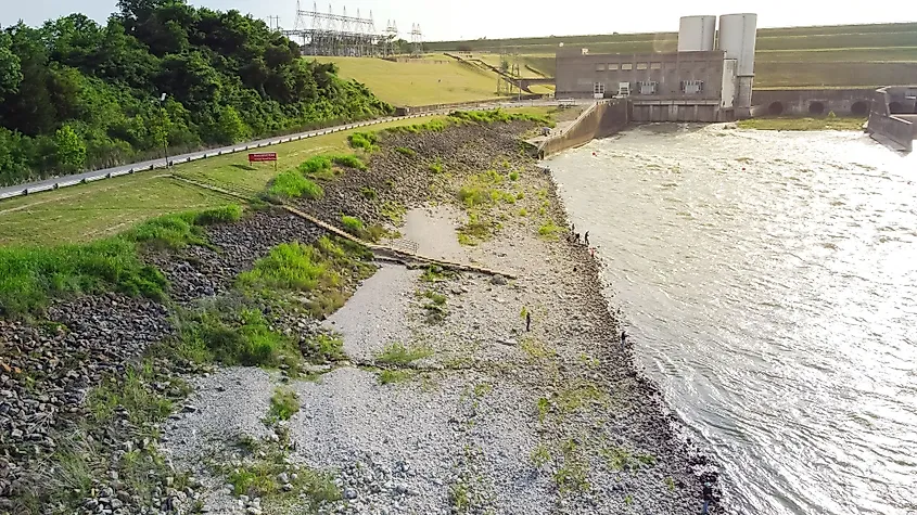 A group of fisherman using long surfing rod fishing on spillway of Denison Dam for striped bass