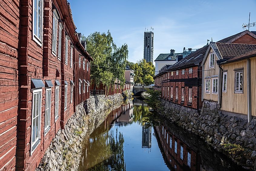 Canal in Västerås, Sweden, lined with buildings and greenery during summer.