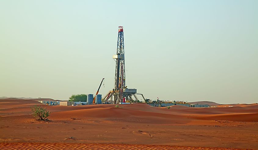 Sunset over oil field in the Red sand Arabian desert near Dubai, United Arab Emirates