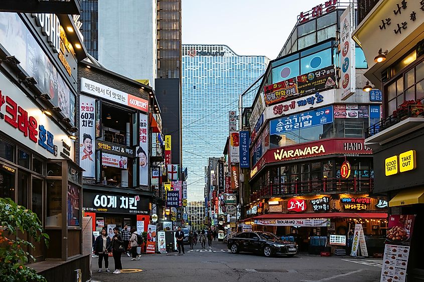 eople near restaurants in Jongno-gu district in Seoul city in evening twilight