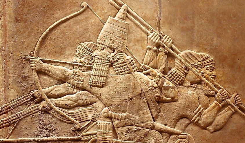 Assyrian relief on wall, Ancient carving on stone from Middle East history. Remains of culture of past civilization, Sumerian art background.