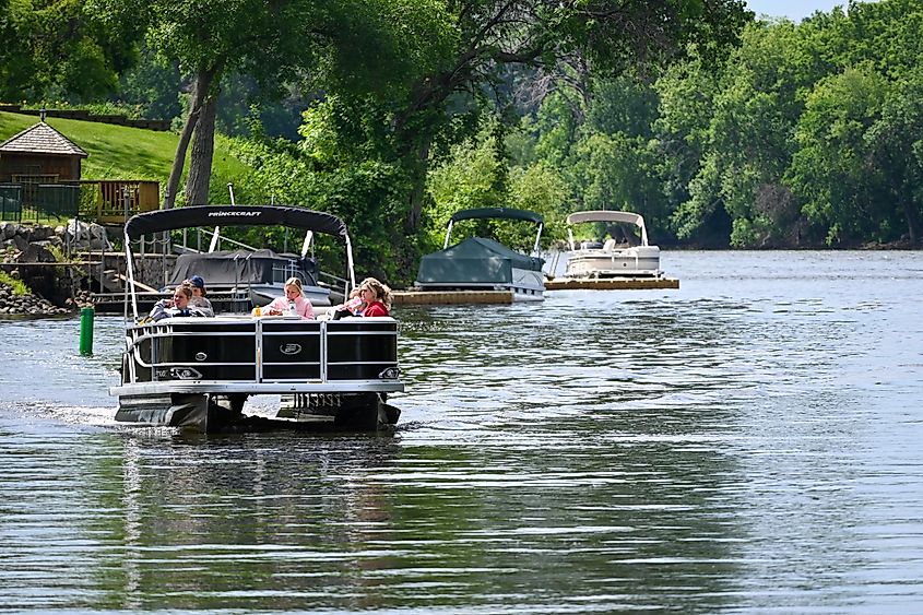 A group of people enjoying a pontoon ride up the Rum River in Anoka, Minnesota.