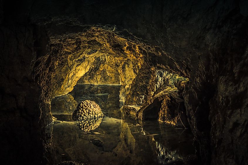 A brain-like rock formation sits on a lake inside Höllgrotten Caves, Baar, Zug, Switzerland.
