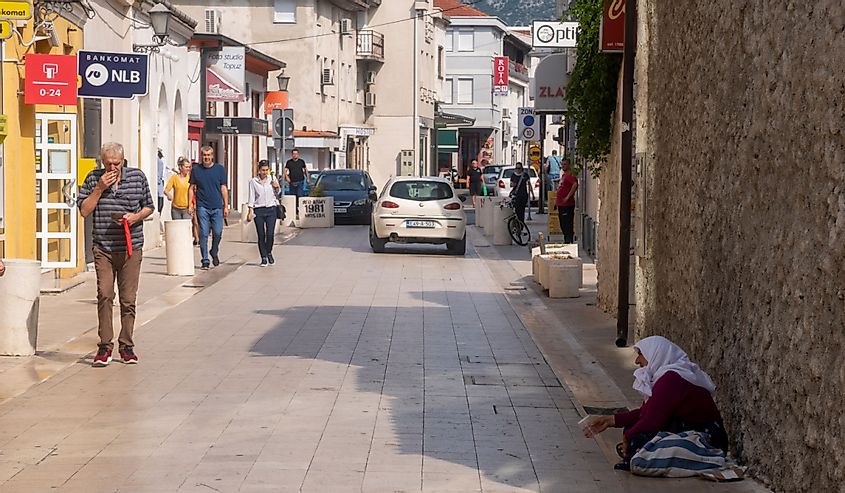 woman begging on the street in the center of Mostar, Bosnia and Herzegovina