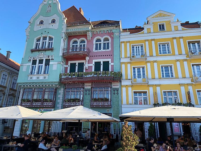 Old, colorful buildings stand above the patrons of fully-booked streetside patios.