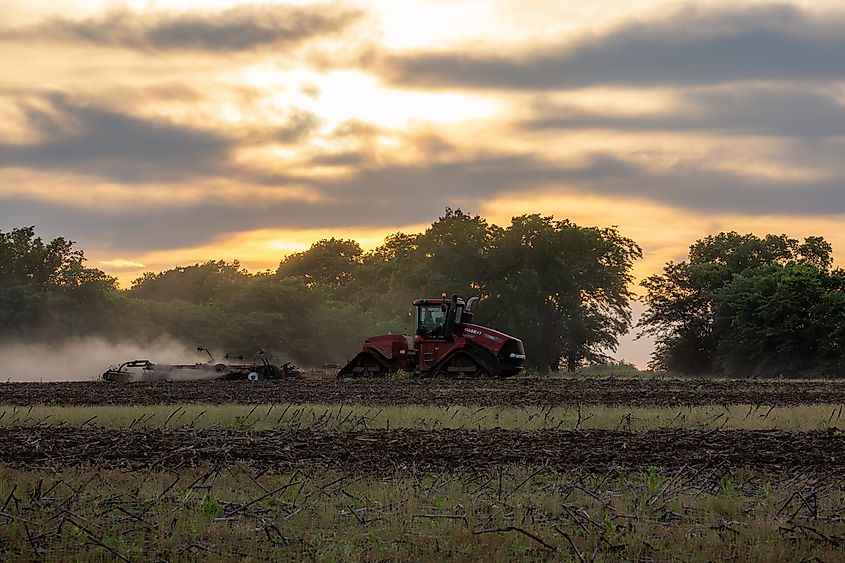 A tractor prepares a farm field in rural Missouri.