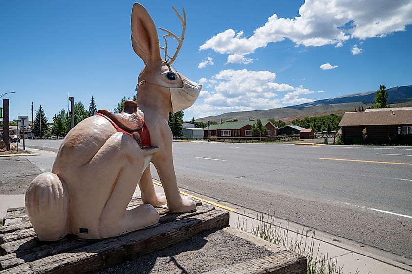 The Worlds Largest Jackalope statue at the gas station along the roadside. Wearing a mask due to COVID-19 Pandemic, Dubois, Wyoming