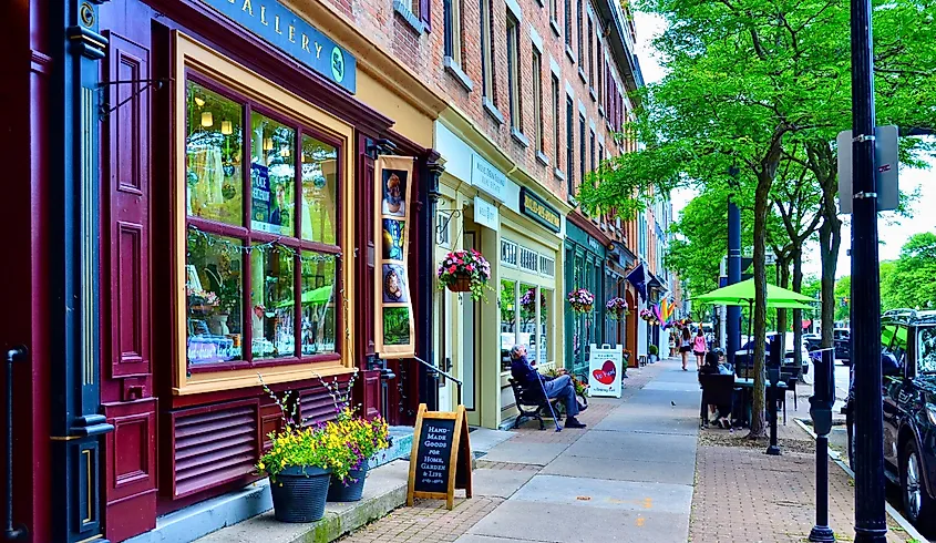 Street view at Skaneateles, New York, with storefronts and people walking down the sidewalk.