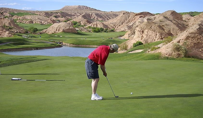 Man putting on the beautiful golf course, Wolf Creek Golf Course in Mesquite, Nevada.