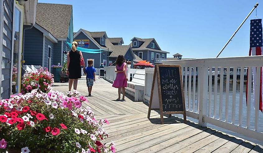 Tourists explore the waterfront shops of Duck.