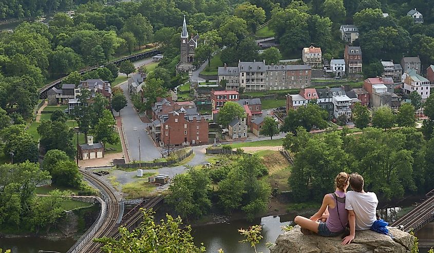 People sitting on a rock overlooking Harpers Ferry