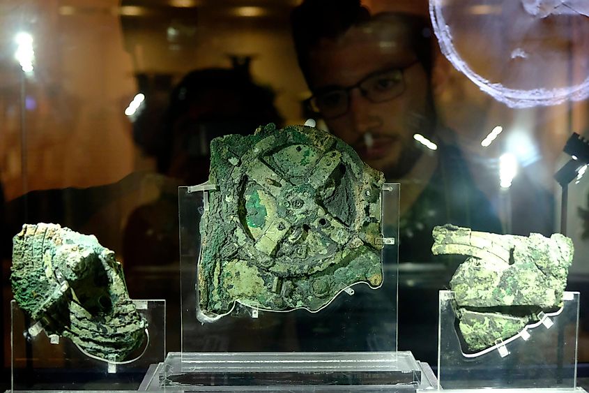 Visitors look at a fragment of the 2,100-year-old Antikythera Mechanism, believed to be the earliest surviving mechanical computing device, is seen at Museum in Athens, Greece 