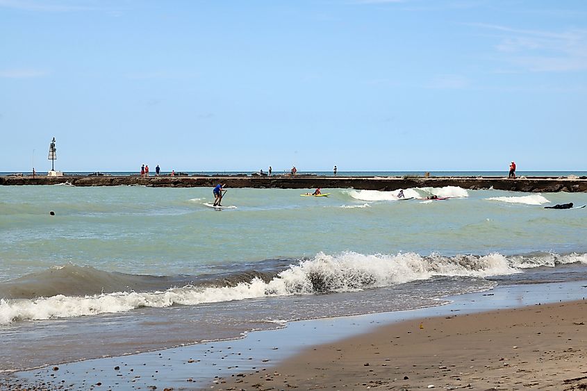 Editorial Photo Credit: Diane Kuhl via Shutterstock. Kincardine, Ontario, Canada on August 28,2018 in the afternoon at Station Beach on Lake Huron. A very wavy day brought the surfers out.