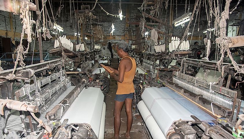 A textile loom factory worker works at traditional loom machine in Burhanpur, Madhya Pradesh, India. 