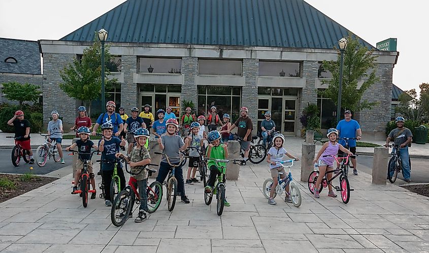 Berea, Ky, US -‎ August ‎25, ‎2018- Berea Pedal with the Police- A group of kids participating in a pedal with the police event posing in front of the Kentucky Artisan Center