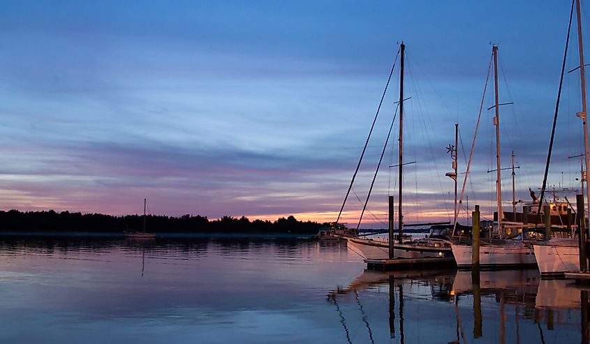 Sailboats sit quietly in calm waters in historic Beaufort, NC. 