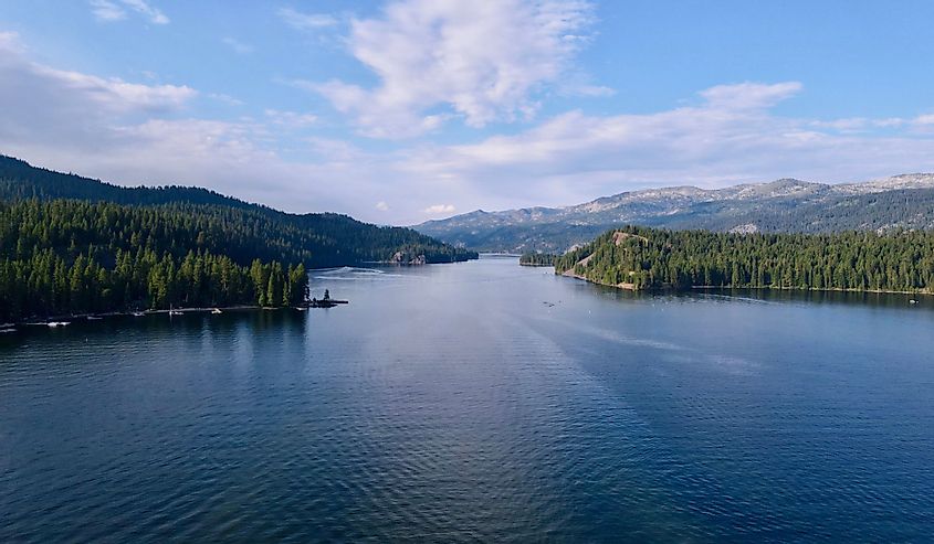 Aerial view of Payette Lake in McCall Idaho surrounded by evergreen trees and mountains.