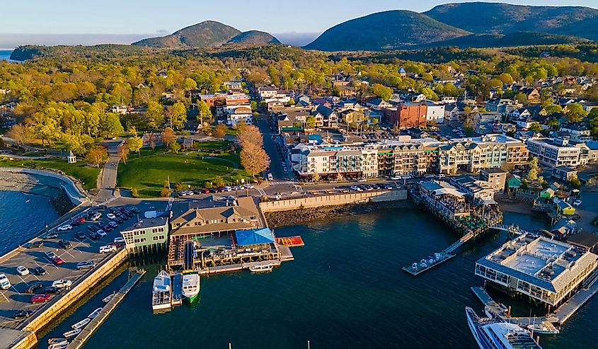 Bar Harbor historic town center aerial view at sunset, with Cadillac Mountain in Acadia National Park at the background, Bar Harbor, Maine ME, USA.
