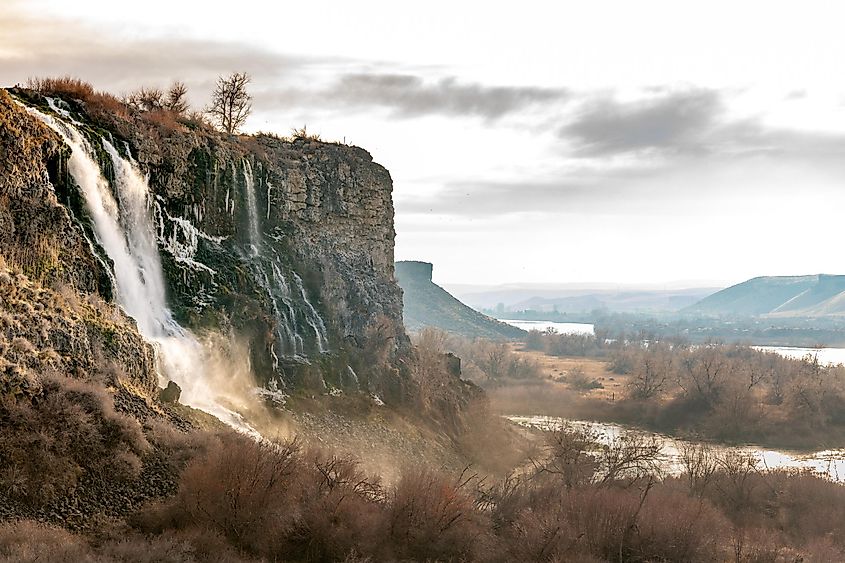 Beautiful waterfall with warm colored mist and Snake River