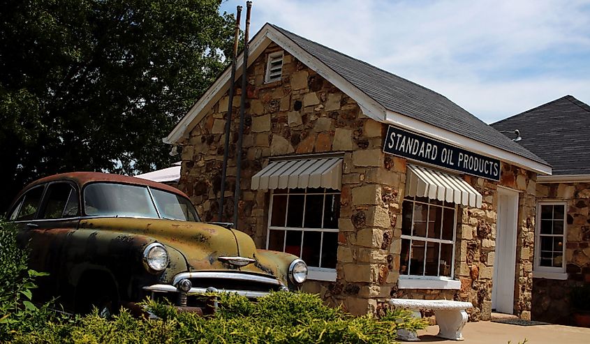 A vintage car next to a rock building on Route 66 in Cuba, Missouri.
