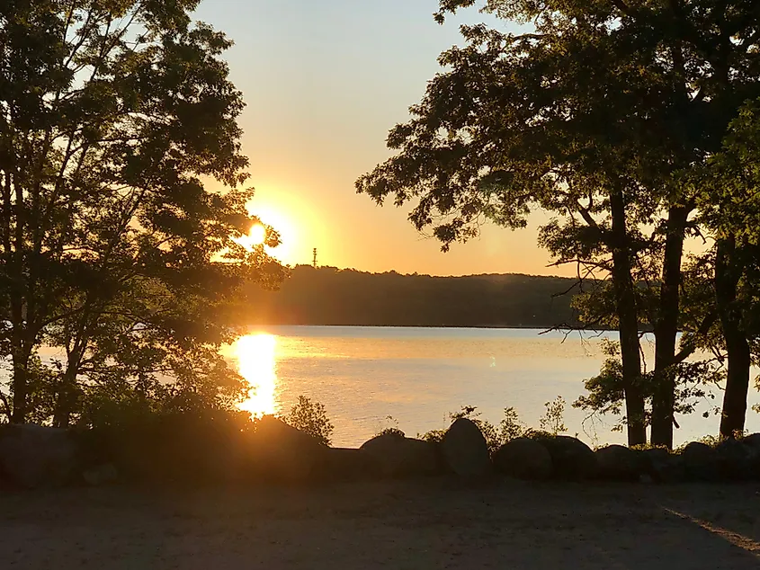 Colorful sunset reflected in Watchaug Pond, Burlingame State Park in Charlestown, Rhode Island