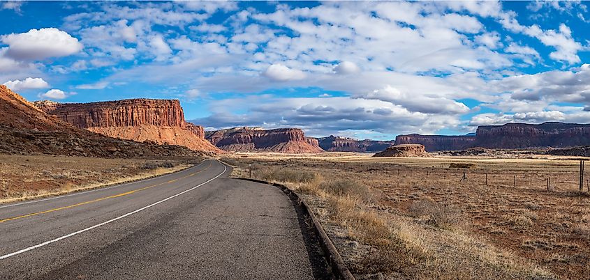 Iconic view of red sandstone buttes and mesas on a sunny day seen along the Indian Creek Corridor Scenic Byway near Canyonlands National Park, Needles District, Monticello, Utah