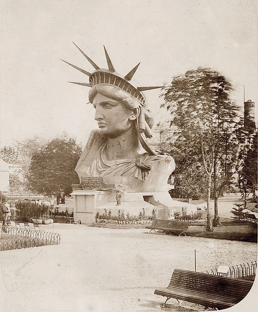 Head of the Statue of Liberty on display in a park in Paris.