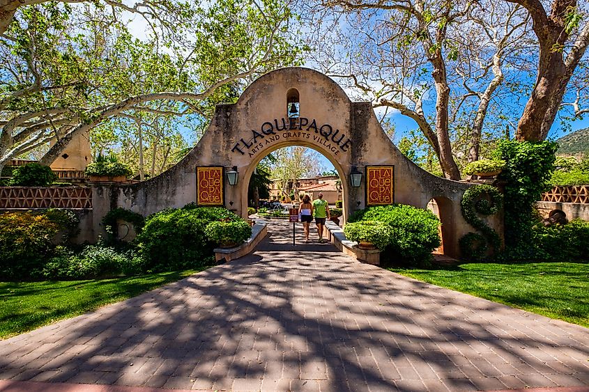 The Tlaquepaque Arts and Crafts Village, with vintage adobe style architecture, is a popular tourist destination filled with retail shops and restaurants in Sedona, Arizona.