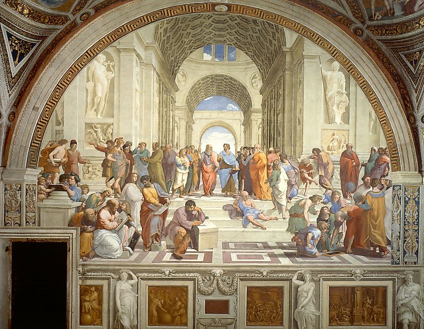 Renaissance fresco showing a large group of ancient philosophers and scholars gathered beneath grand arches, with Plato and Aristotle standing near the center.