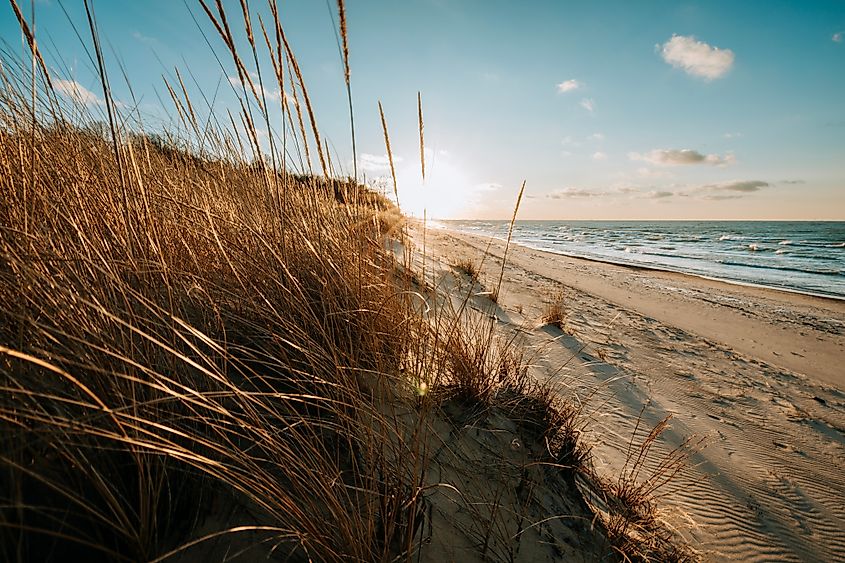 Sun sets over a beach on Lake Michigan in Indiana Dunes National Park. 