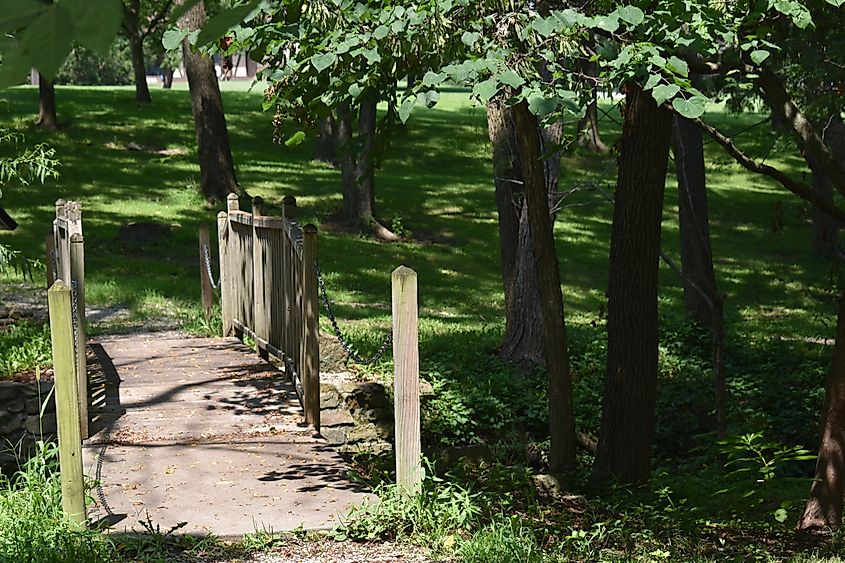 A wooden bridge in the serene Hidden Waters Nature Park in Marshville, Missouri.