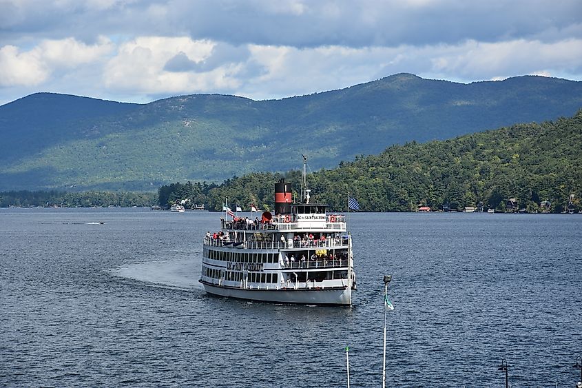 Editorial Photo Credit: Ritu Manoj Jethani via Shutterstock. LAKE GEORGE, NY - SEP 24: Lac Du Saint Sacrement cruise on Lake George in New York, as seen on Sep 24, 2016. It is a long, oligotrophic lake located at the southeast base of the Adirondack Mountains.