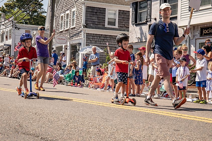 Children on scooters in 4th of July parade Chatham Massachusetts July 4. 