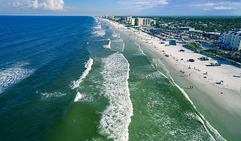 Aerial view of people on the sandy beach in New Smyrna Beach