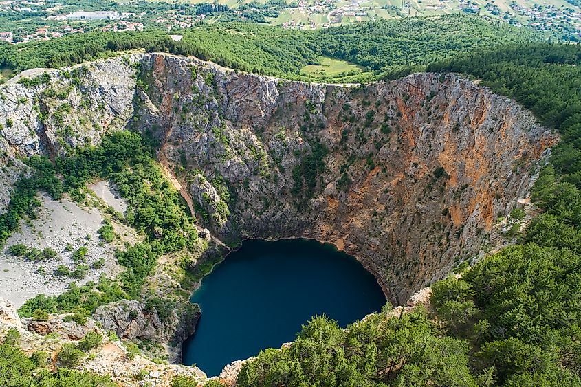 Beautiful nature and landscape photo of Red Lake in Imotski Dalmatia Croatia on warm summer day. Nice colorful image of mountains and lake shot with drone fro