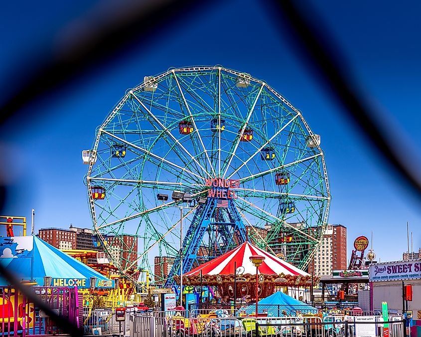 The famous Wonder Wheel in Coney Island. The Eccentric Ferris Wheel was built in 1920, it has 24 fully enclosed cars, giving a total capacity of 144 passengers. Editorial credit: Jerome LABOUYRIE / Shutterstock.com