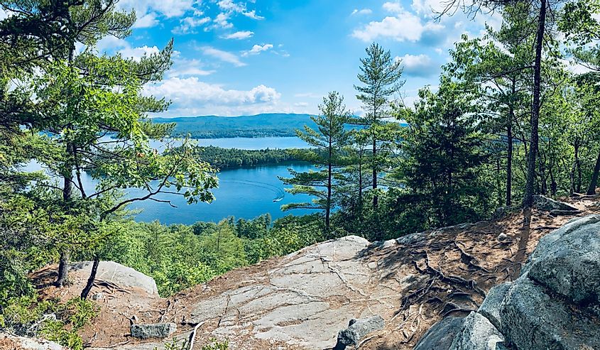 Panoramic view of Newfound Lake and Follansbee cove near wellington state park beach from summit of Sugarloaf mountain near Bristol, New Hampshire