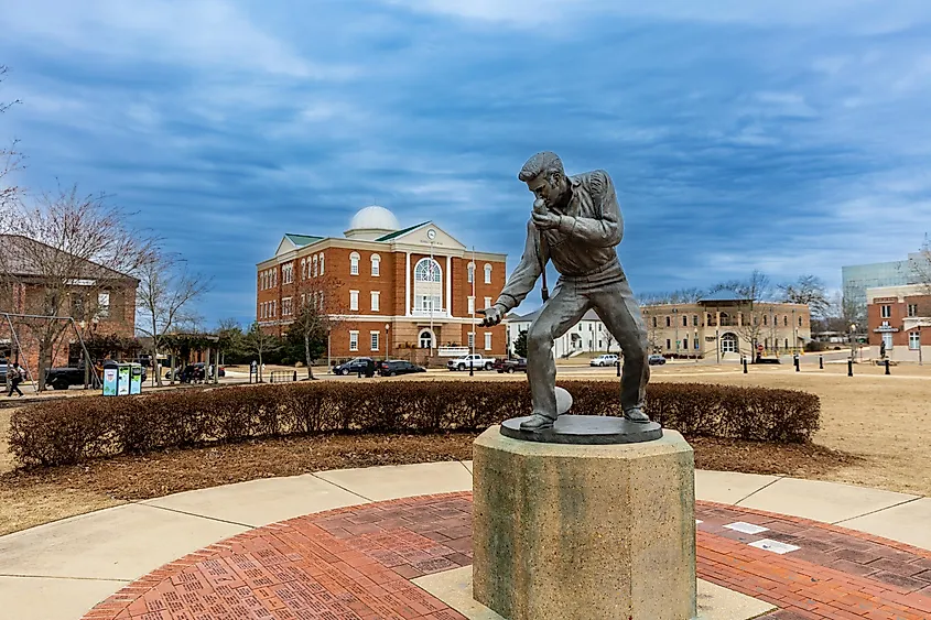 Elvis Presley Statue in Tupelo, Mississippi, with City Hall in the background.