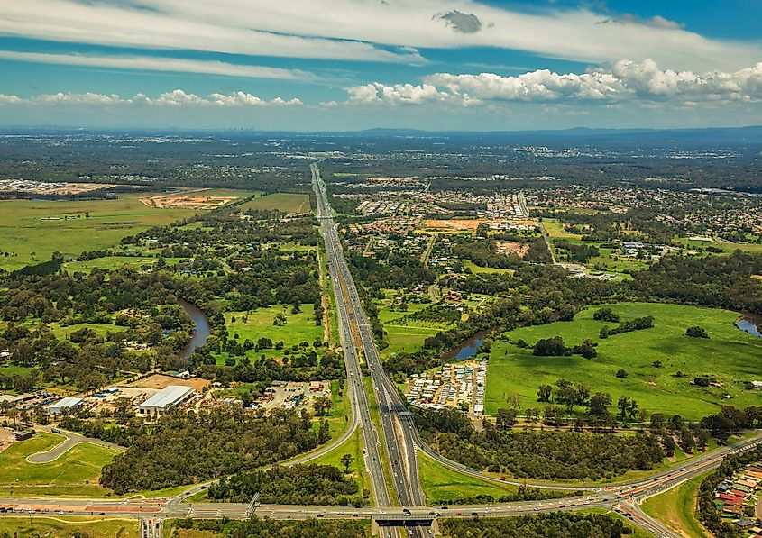 Aerial view of Caboolture and Bruce highway to Brisbane with Bribie Island Road crossing, Queensland, Australia.