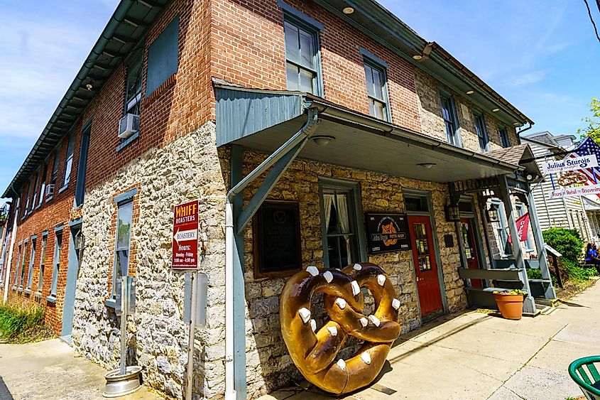 Exterior view of the Julius Sturgis Pretzel Bakery, the first commercial pretzel bakery in the US, with a distinctive large pretzel sign, via George Sheldon / Shutterstock.com